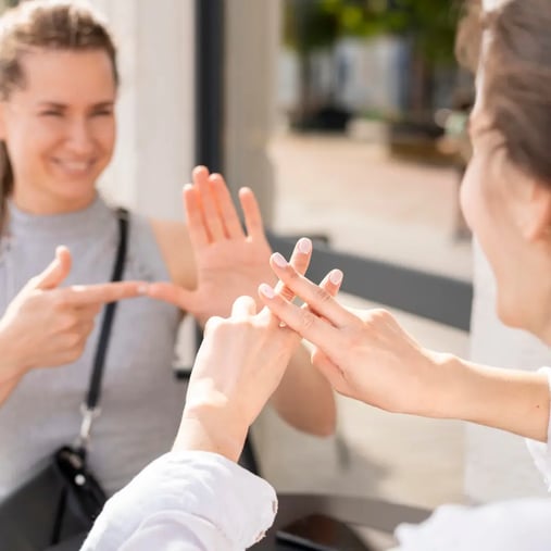 deaf-women-communicating-through-sign-language 1