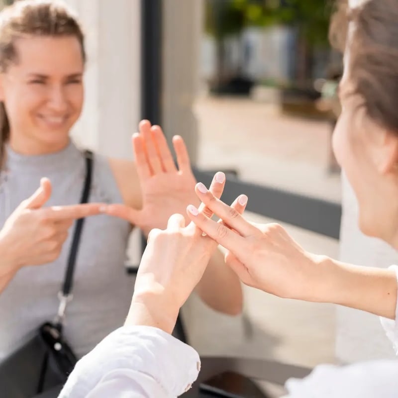 deaf-women-communicating-through-sign-language 1